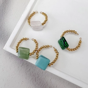 Set of four 18K gold beaded stainless steel rings featuring colorful natural stone centers