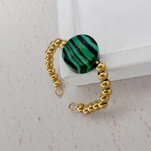 Close-up of 18K gold-plated ring featuring a round green malachite stone inlay
