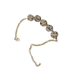 Golden stainless steel bracelet featuring five natural Dalmatian Stone beads and a lobster clasp