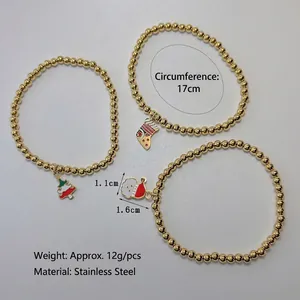 Gold stainless steel beaded elastic bracelet with Christmas tree and Santa charms