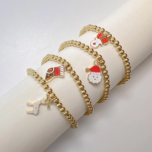 Set of 4 Christmas gold beaded elastic bracelets featuring Santa and reindeer charms