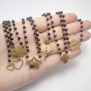 Black glass beaded necklace with golden heart and palm leaf charms for women