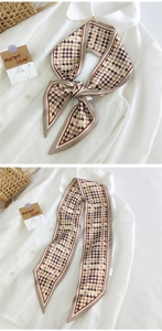 Détail d'un foulard étroit rétro à motif pied-de-poule marron et blanc, effet soie