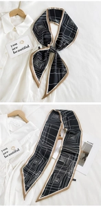 Detail of thin long silk scarf with abstract geometric pattern used as a chic neckerchief