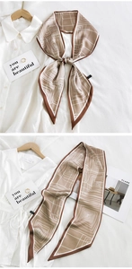 Close-up of long silk scarf with brown geometric patterns and elegant decorative details