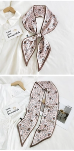 Detail of pink paisley silk skinny scarf used as a stylish bag handle wrap accessory