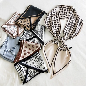 Chic long satin neck scarves with houndstooth and paisley prints on soft white fabric