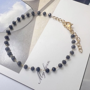 Close-up of black beaded bracelet with gold lobster clasp on My Love display card