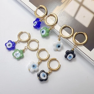 Set of four gold stainless steel flower hoop earrings with colorful Evil Eye charms