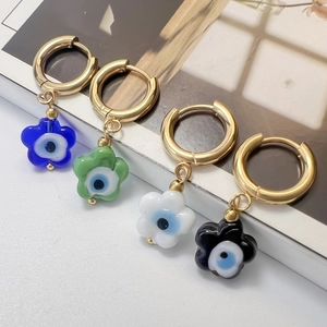 Gold floral hoop earrings with colorful Evil Eye flower pendants in blue green white black