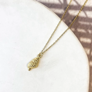 Detailed view of gold starfish shell pendant on elegant chain with natural textures