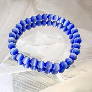 Detailed view of dark blue cat eye stone beaded bracelet with 8-10mm round beads