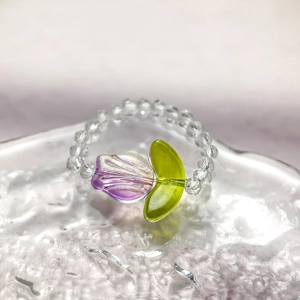 Detail of purple tulip glass flower ring with transparent faceted crystal beads