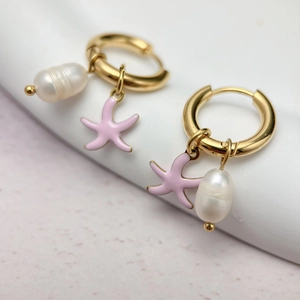 Detail of gold starfish hoop earrings with pink enamel and white baroque pearls