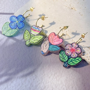 Detailed close-up of colorful floral C-shaped earrings with artistic oil painting texture