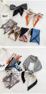 Various narrow printed scarves displayed flat with heart and stripe patterns