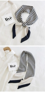 Close-up of navy and white striped skinny silk scarf used as a versatile neck tie