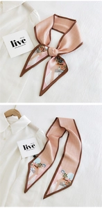 Detail of light pink silk necktie scarf with grid pattern and scene illustration