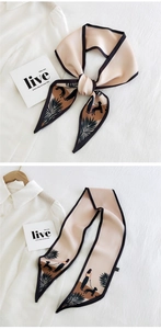 Detail view of pink long twilly silk scarf with minimalist black illustration art on shirt