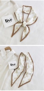 Detail of white twilly scarf with gold ginkgo leaves shown as bow and hanging styles