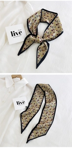 Detail of floral skinny scarf with tulip prints and black contrast edges on beige silk