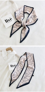 Close-up of floral print satin skinny scarf styled with a white shirt and ribbon knot