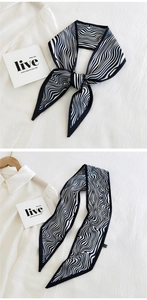 Detail of black and white zebra pattern narrow silk scarf with premium stitched edges