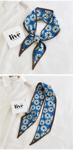 Close-up of slim blue geometric print silk scarf tied on a classic white shirt
