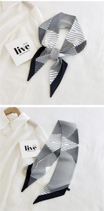 Detail of a black and white geometric striped twilly scarf styled on a white shirt
