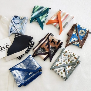 Collection of patterned long silk scarves in 100% polyester displayed on a white background