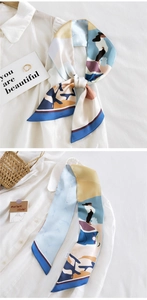 Détail d'un foulard étroit en soie artistique avec des motifs d'illustration modernes