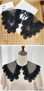 Detail view of exquisite black lace false collar featuring intricate crochet floral patterns