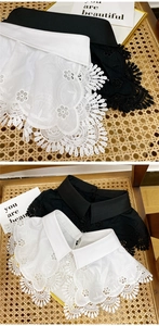 Close-up of floral embroidery and scalloped lace trim on elegant detachable collars
