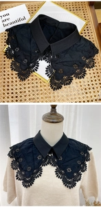 Detail of black floral lace detachable shirt collar with embroidery on a beige sweater