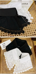 Close-up of floral embroidery and hollow lace edges on black and white fake collars