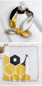 Detail of square silk scarf with giraffe pattern and yellow geometric honeycomb print