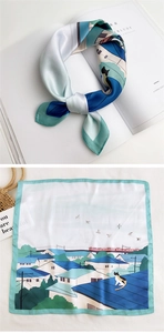 Detailed view of square silk scarf with artistic cat and blue rooftop illustration