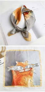 Detail of silk square scarf showing cartoon cat print and delicate yellow stitched edges