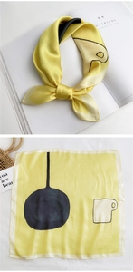 Artistic yellow silk square scarf with abstract teapot print and stylish lifestyle props