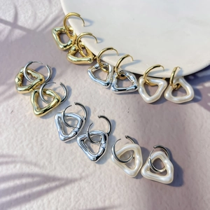 Modern geometric hollow triangle earring set in polished gold, silver, and pearl finishes