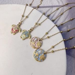 Golden 18K stainless steel ocean necklaces with sea turtle and starfish enamel pendants