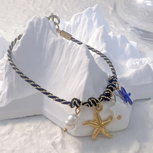 Colorful woven bracelet with starfish pendants and pearl detail for bohemian autumn style