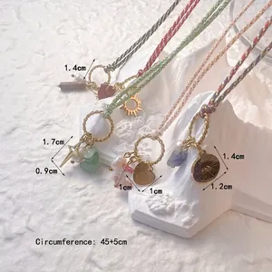 Bohemian braided rope necklace with sun pendant, natural stones and pearls on white background