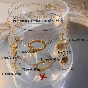 Goldenes Edelstahl-Armband mit Meeresmotiven wie Seestern Muschel und Perlen