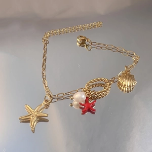 Goldenes Edelstahl-Ozeanarmband mit Seestern, Muschel-Anhängern und weißer Perle