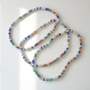Detailed view of colorful faceted crystal beads in a triple-layered stretch bracelet
