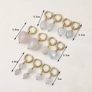 Golden geometric earrings set with natural pink stones in various elegant shapes