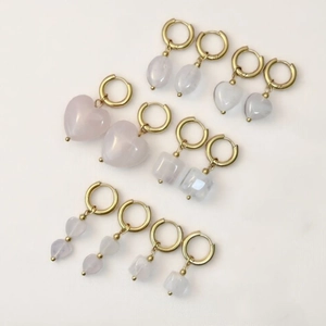 Set of gold stainless steel hoop earrings with various natural rose quartz stone charms