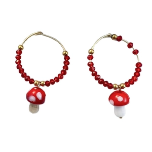 Golden hoop earrings with red faceted beads and white-dotted red glass mushroom charms