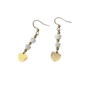 Golden drop earrings featuring white star beads and heart pendants on white background